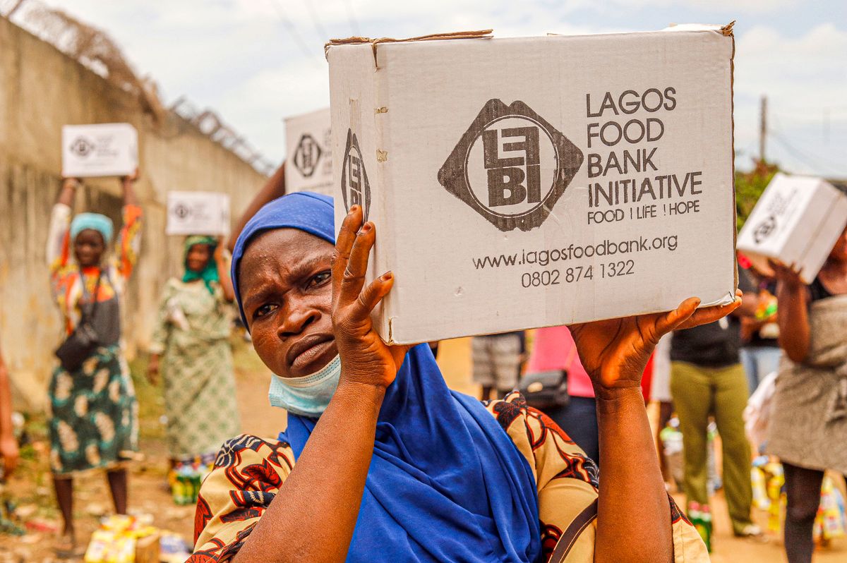 Volunteers distributing food aid boxes at a community food bank