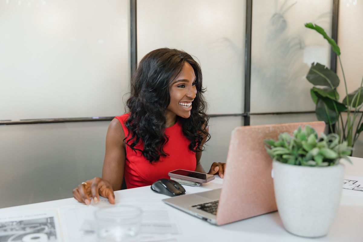 Small business owner working at her desk with a laptop